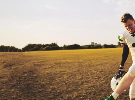 injured football player being carried by teammates.