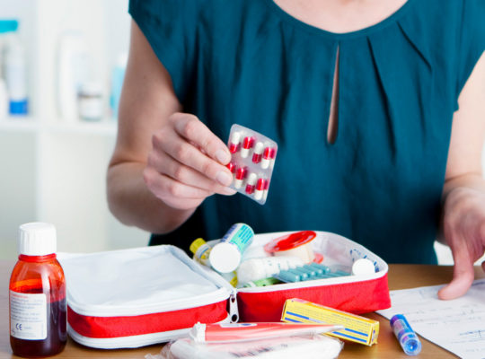 woman making a custom first aid kit