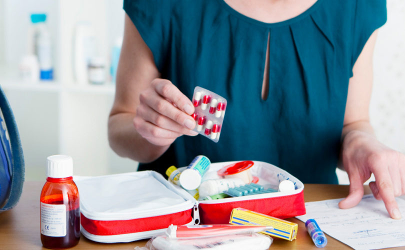 woman making a custom first aid kit