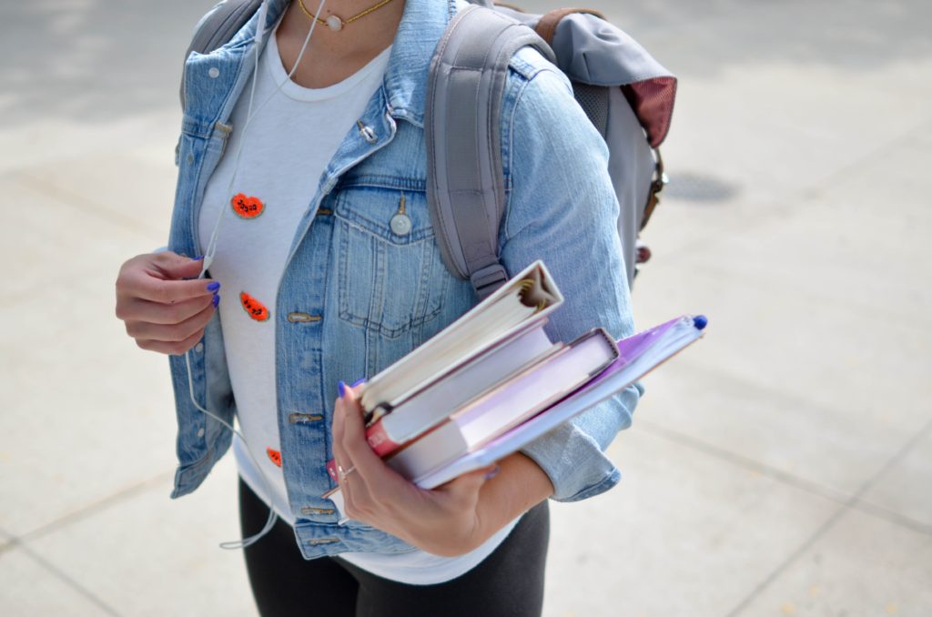 girl holding school books 