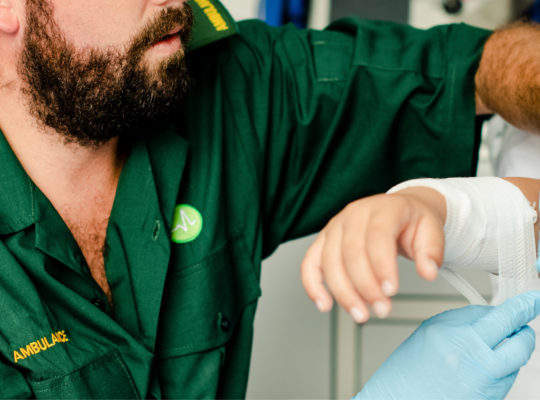 arm injury being wrapped in gauze by paramedic