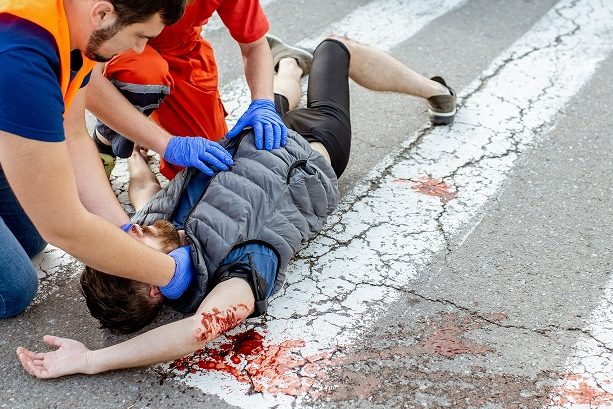 injured man receiving emergency care for severe bleeding.