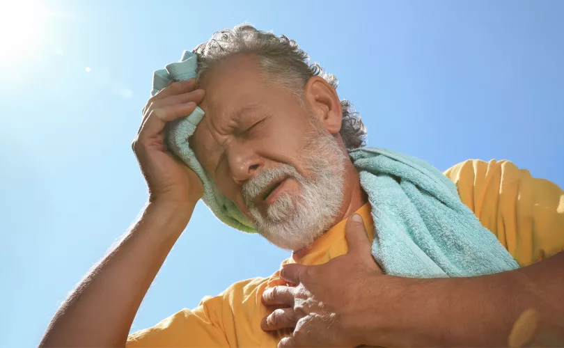 older man suffering from heat stroke or heat stress