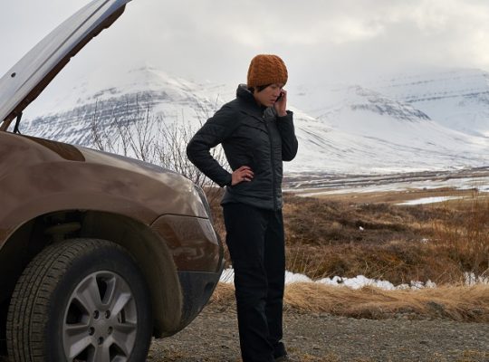 car troubles in winter, stranded woman in theecold.