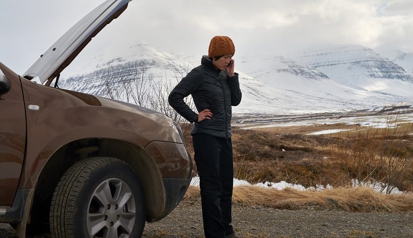 car troubles in winter, stranded woman in theecold.
